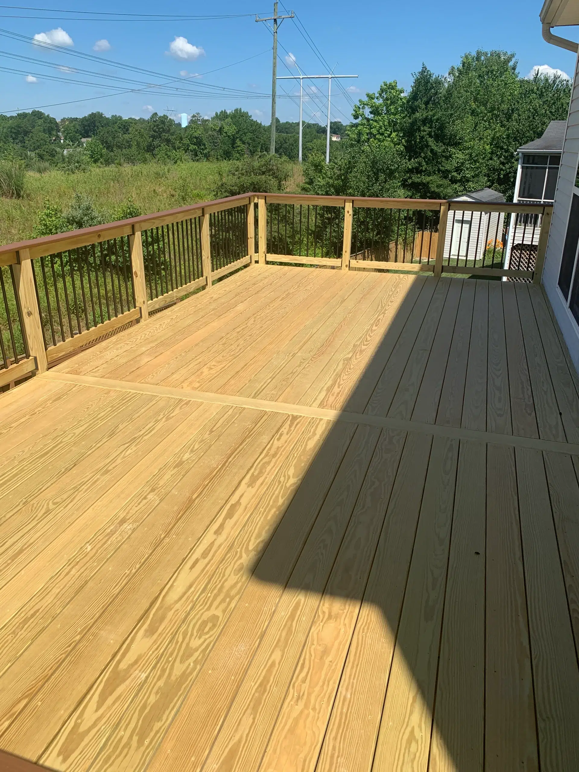 pressure-treated-wood-deck-with-wooden-railing-in-the-virginia